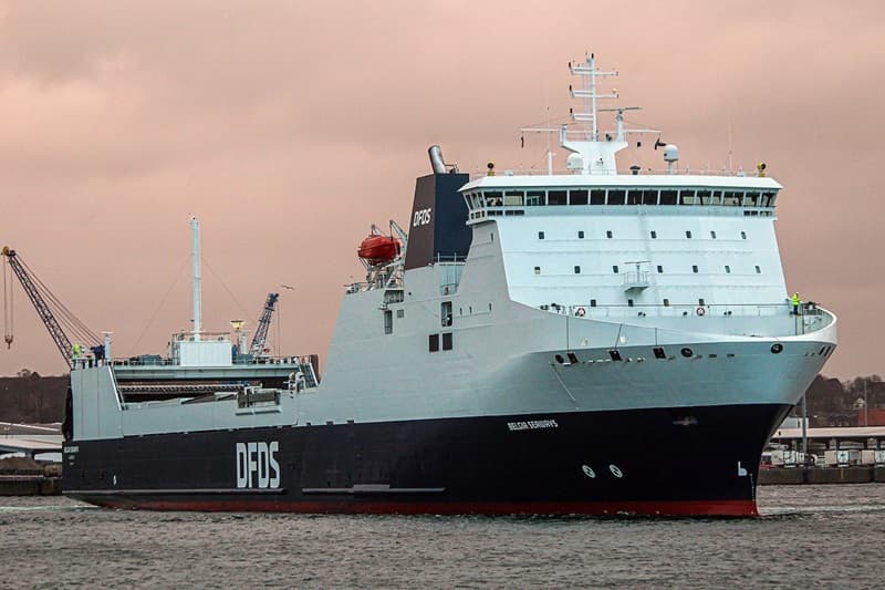 DFDS vessel Belgia Seaways sailing in the harbour, with a crane in the background