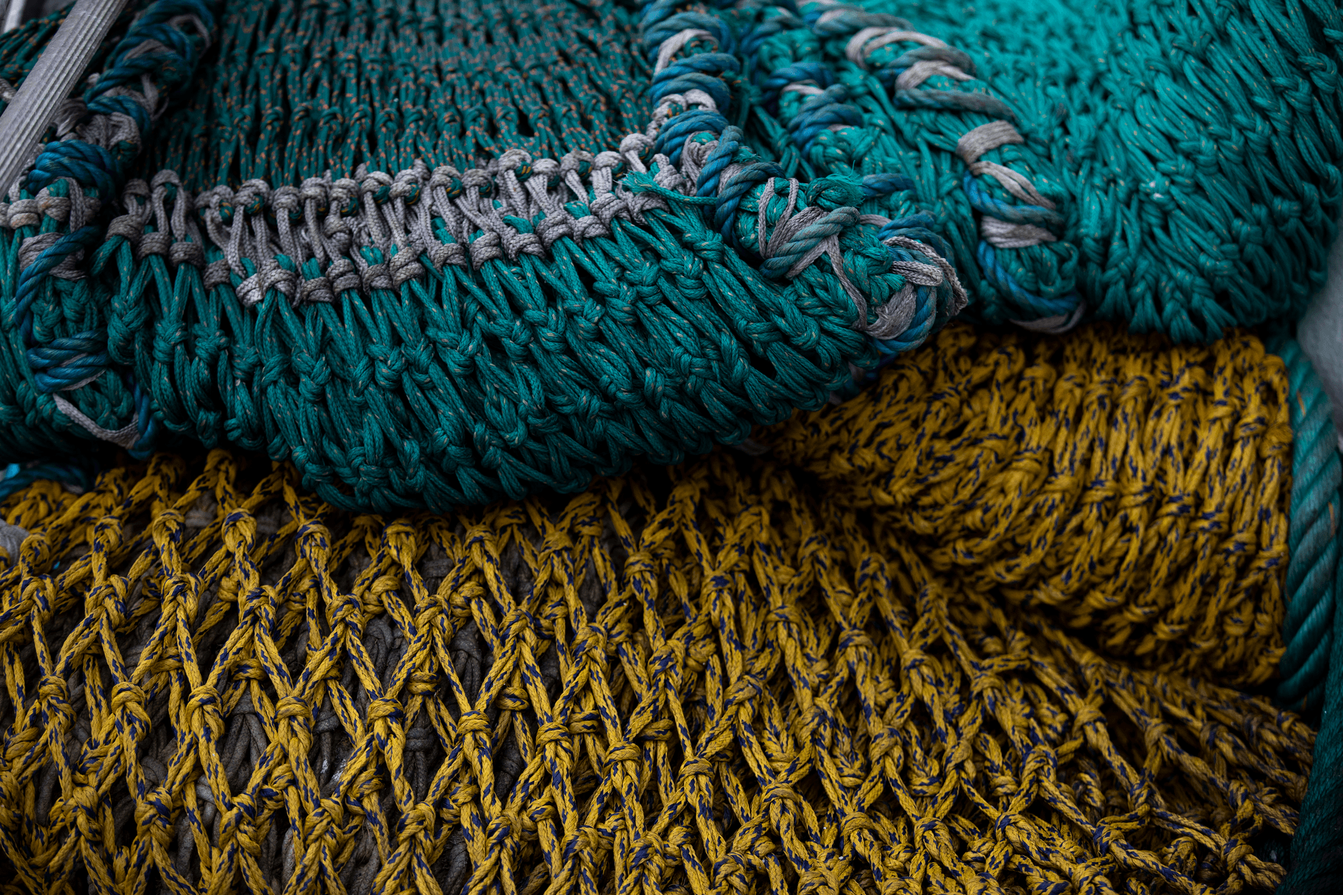 Close-up of yellow and blue fish nets stacked on top of each other at a DFDS cold storage facility