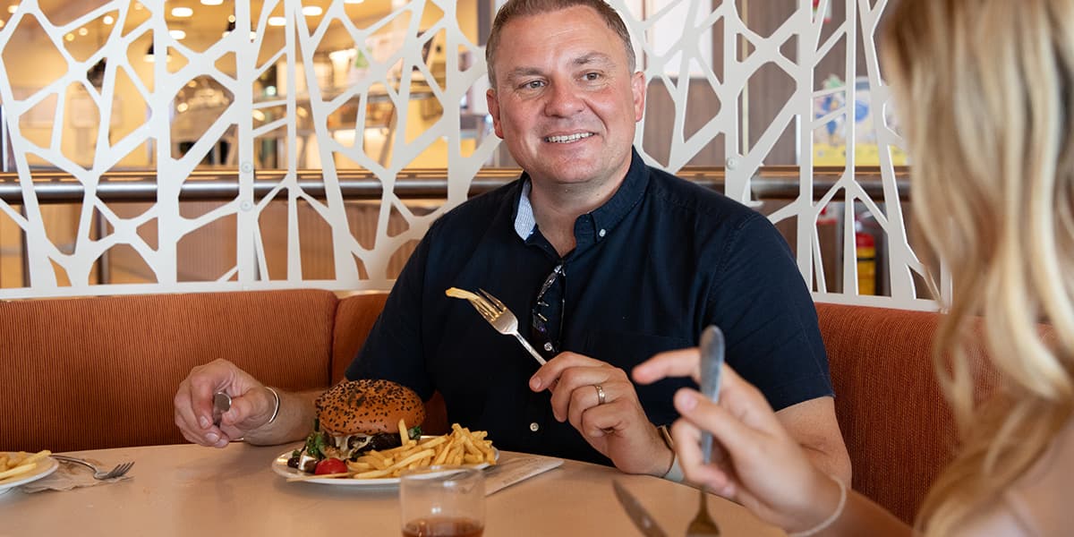 Couple enjoying a meal on Athena Seaways (exp June 2027)