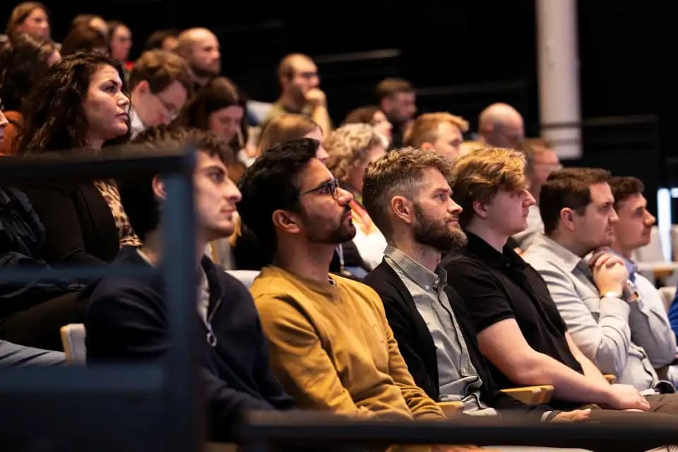 A group of people listening to the Geminor townhall presentation.