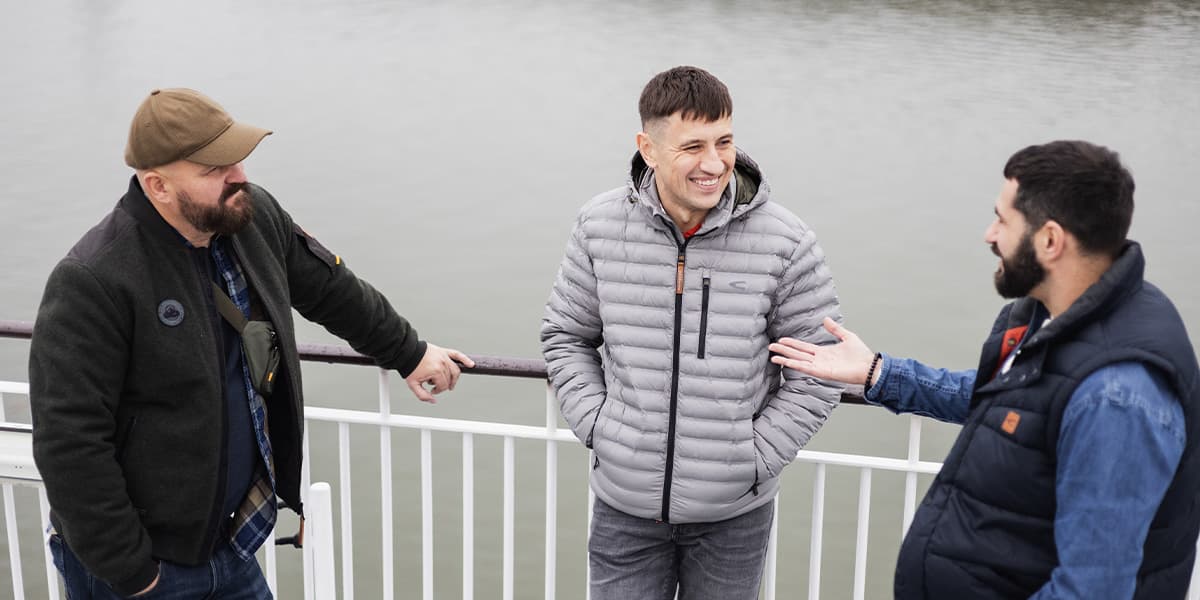 Three men chatting on a DFDS ferry